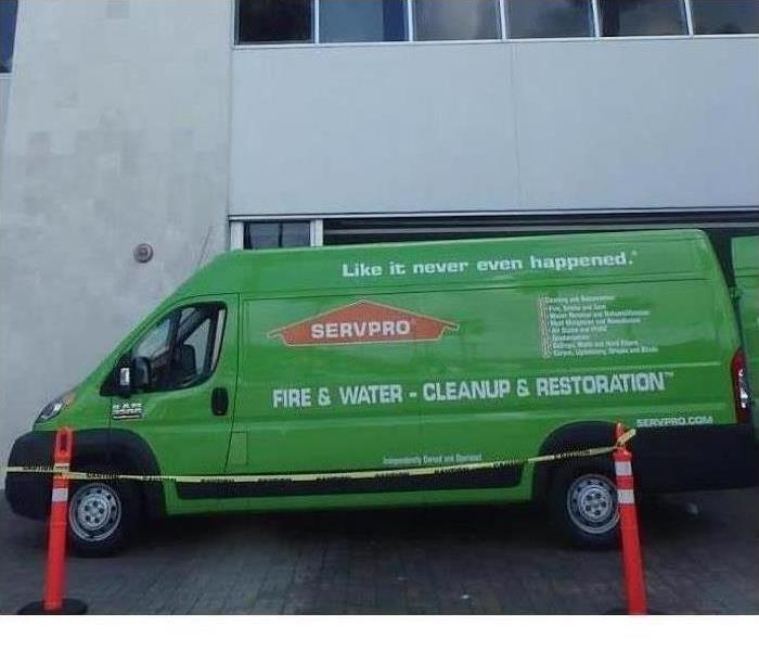Servpro van parked in front of a commercial building.